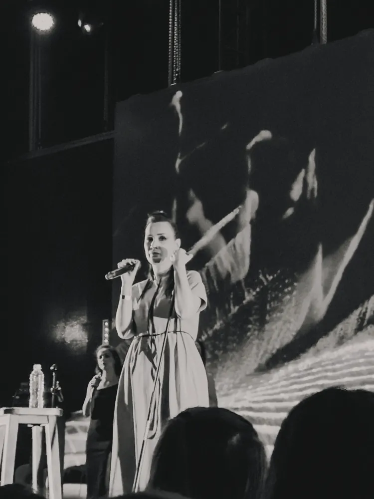 Black and white photo of Ukrainian singer Krykhitka performing live on stage.